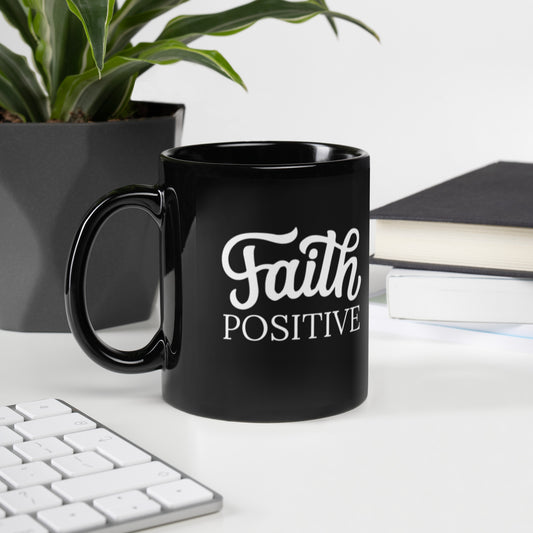 Faith Positive 11 oz mug. Black in color with the Faith Positive logo in white.