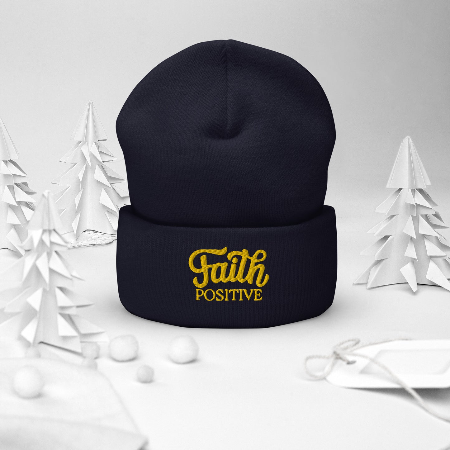 Faith Positive Cuffed Beanie. The Faith Positive logo is Embroidered with yellow thread on the cuff of the beanie. Hat is navy blue in color.