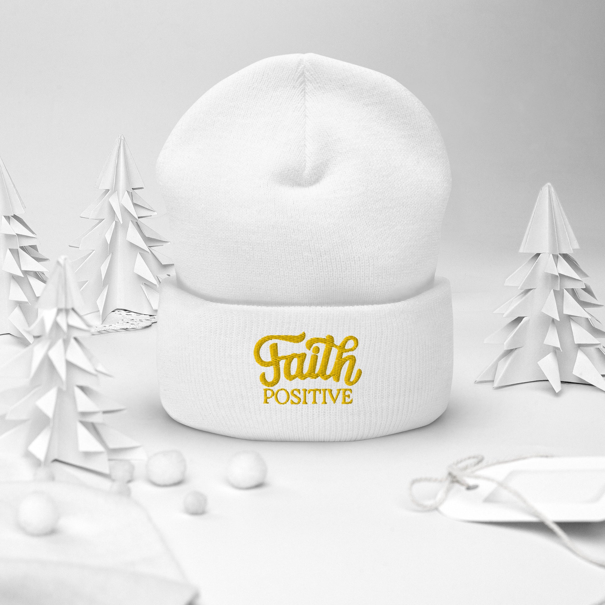 Faith Positive Cuffed Beanie. The Faith Positive logo is Embroidered with yellow thread on the cuff of the beanie. Hat is white in color.