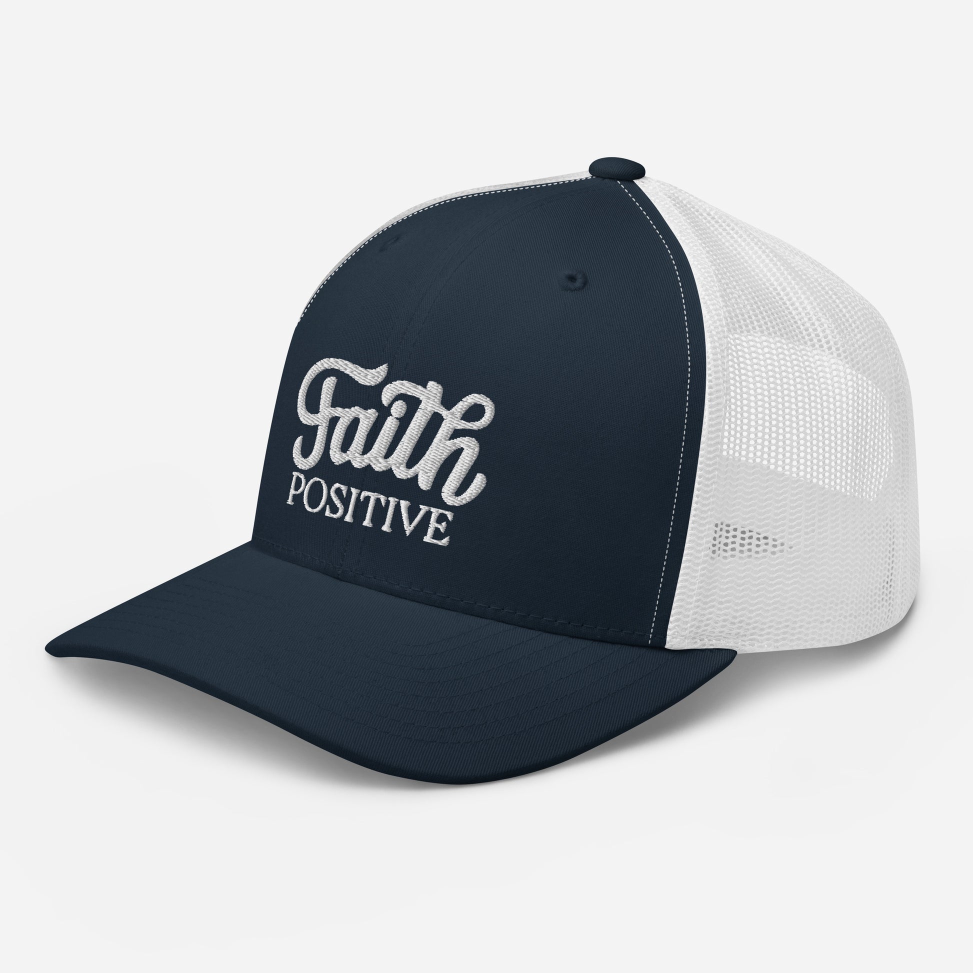 This is the Faith Positive Original trucker hat. The Faith Positive logo is embroidered on the front with white thread. This hat has a white mesh back with a navy blue front and bill. This is the side view of the product.