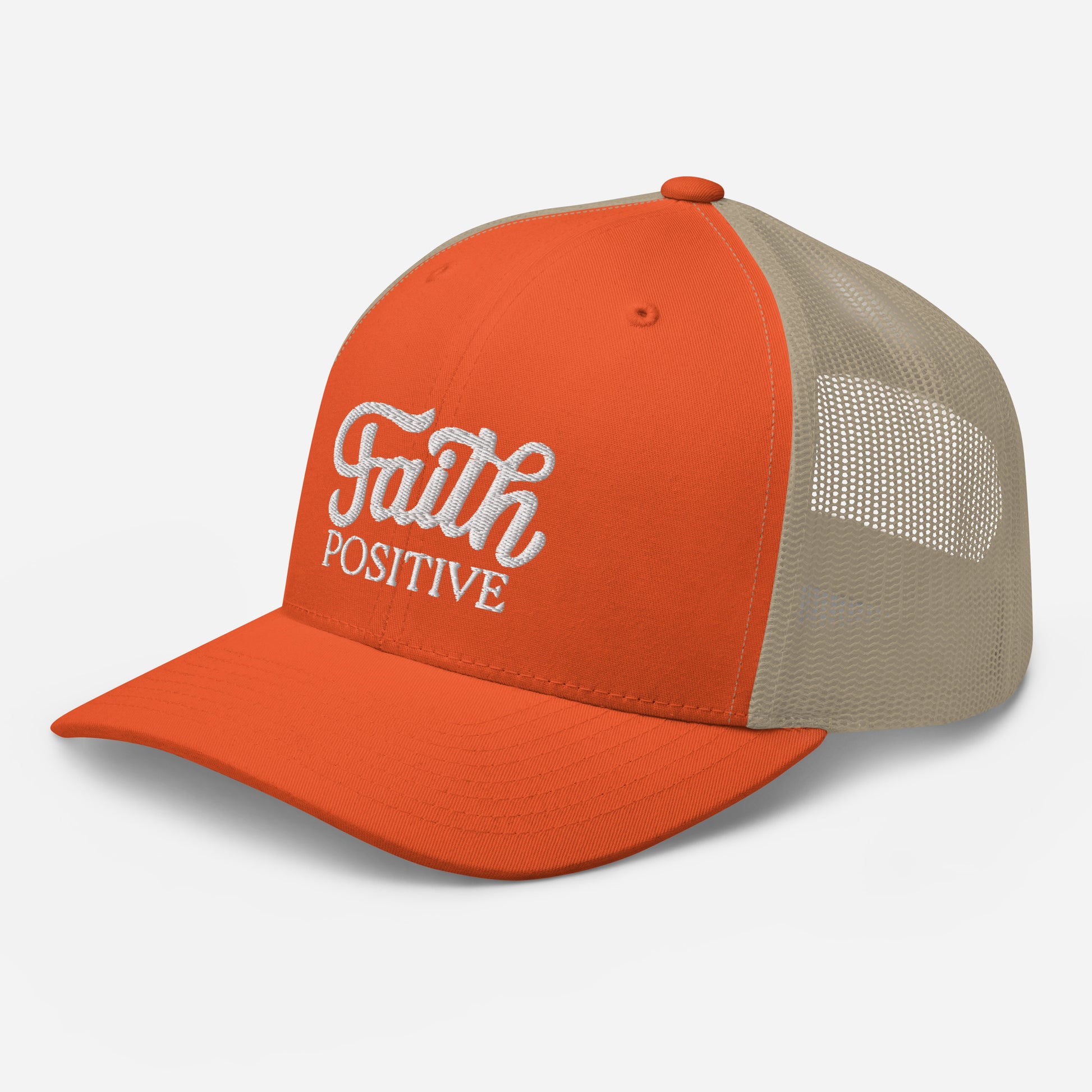 This is the Faith Positive Original trucker hat. The Faith Positive logo is embroidered on the front with white thread. This hat has a khaki mesh back with an orange front and bill. This is the side view of the product.