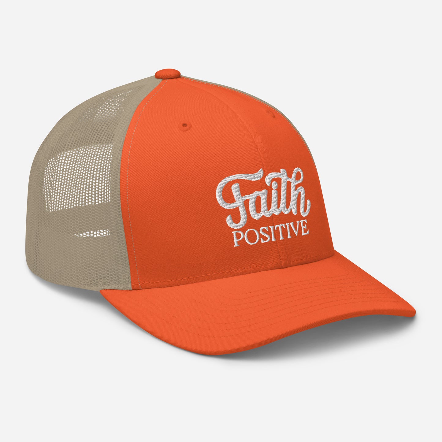 This is the Faith Positive Original trucker hat. The Faith Positive logo is embroidered on the front with white thread. This hat has a khaki mesh back with an orange front and bill. This is the side view of the product.