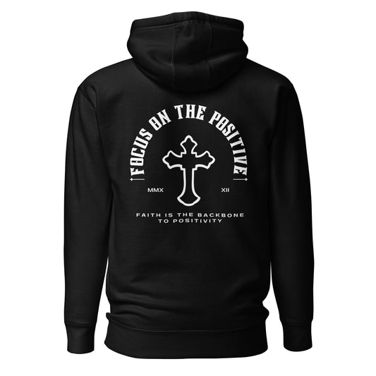 This is the Positive Arch Hoodie. White ink illustrates the words "focus on the positive" as an arch with a cross in the middle. The roman numerals of 2022 are split up on either side of the cross and the quote "Faith is the backbone to positivity" is written underneath. The design is on the back. Hoodie is black in color. View shows the back of the product.