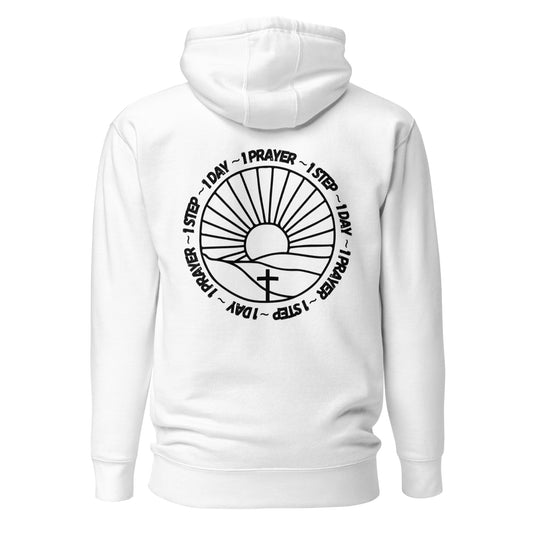 One prayer, one step, one day hooded sweatshirt. There is black lettering surrounding a sun on the horizon, shining on a cross. (White in color)