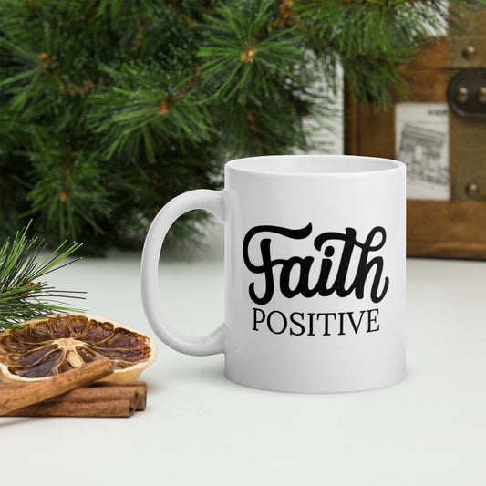Faith Positive mug, white in color with the Faith positive logo in black.