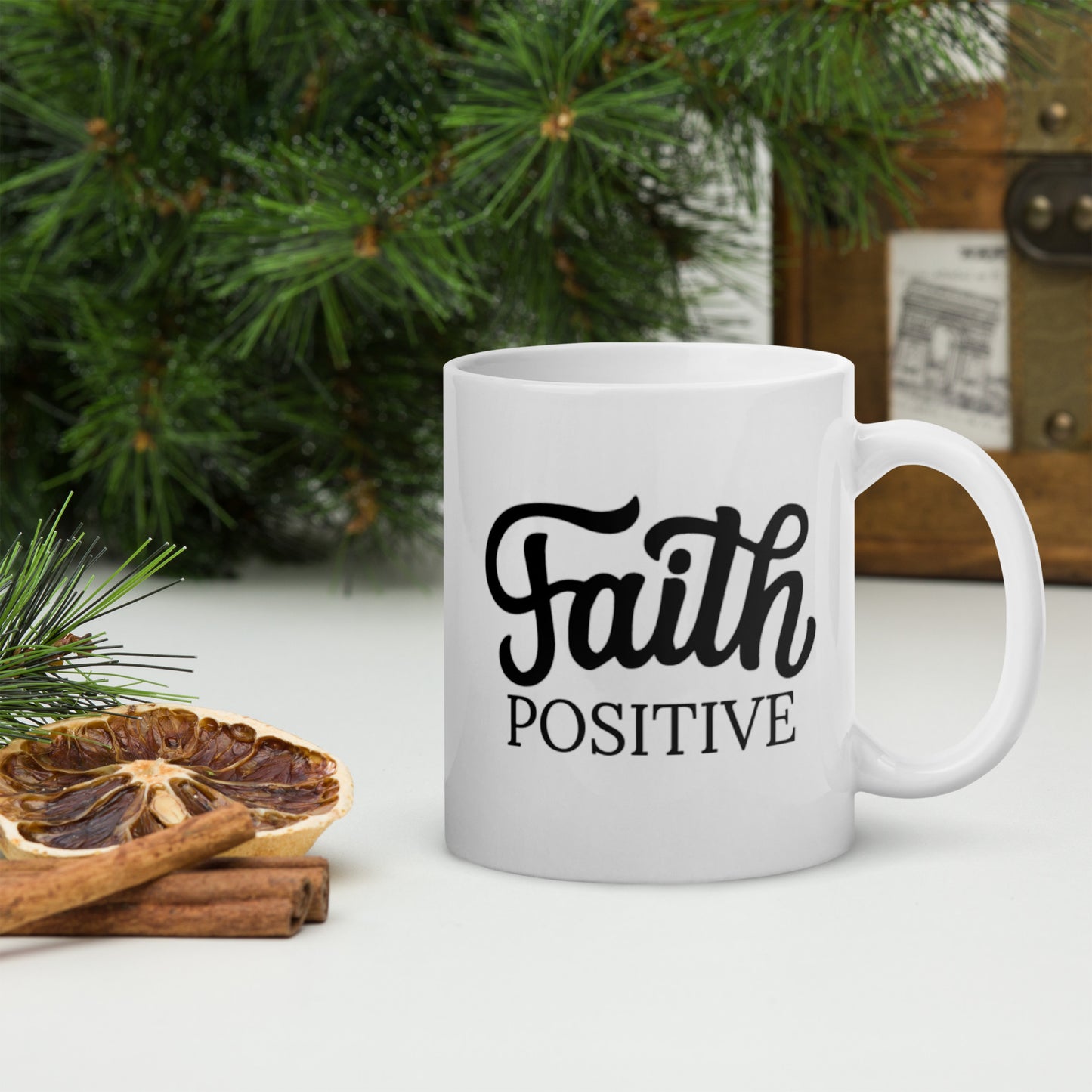 Faith Positive mug, white in color with the Faith positive logo in black.